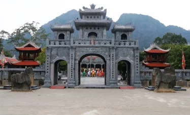 Ancient temple entrance with mountain backdrop in Sapa, showcasing cultural exploration and scenic b.