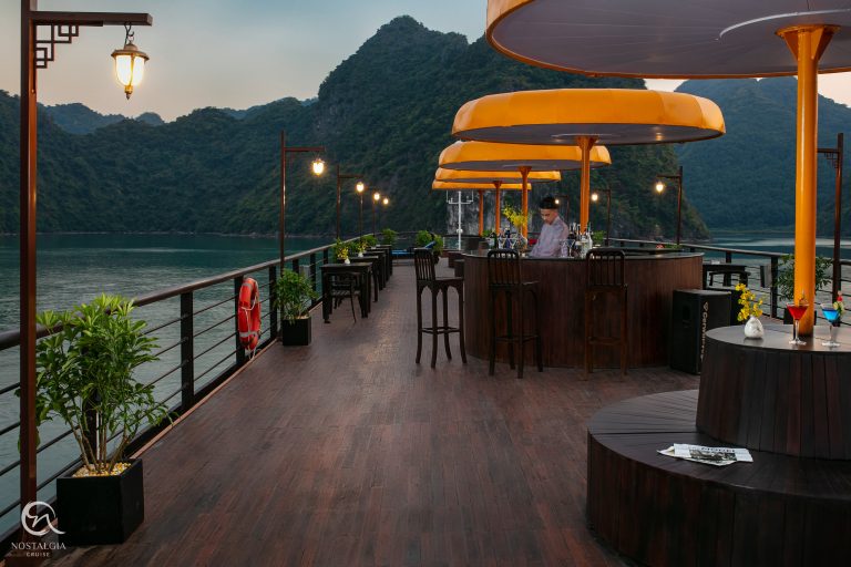 Lan Ha Bay cruise balcony with scenic mountain views and luxurious amenities.