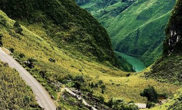 Breathtaking view of lush green mountains and winding roads in Ha Giang, perfect for adventure and n.