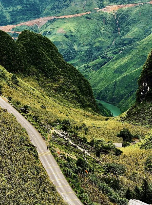 Breathtaking view of lush green mountains and winding roads in Ha Giang, perfect for adventure and n.