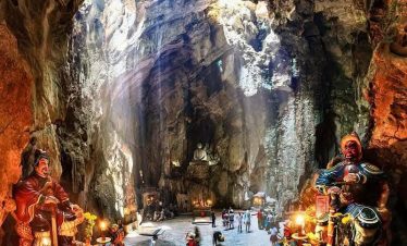 Cave temple with intricate statues and serene atmosphere in Vietnam.
