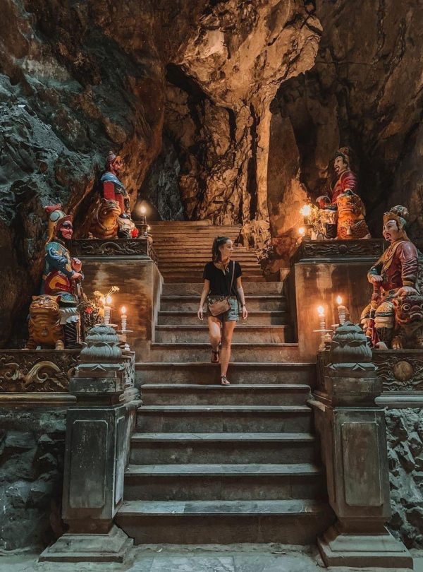 Hanoi Cave Temple with statues and candles creates a mystical atmosphere.