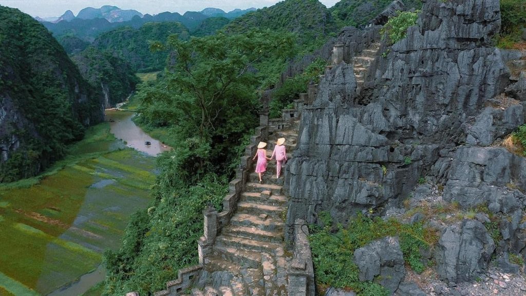 A serene scene of travelers exploring Sapa's rugged trails amidst stunning mountain landscapes.