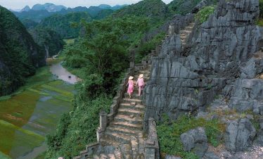 A serene scene of travelers exploring Sapa's rugged trails amidst stunning mountain landscapes.