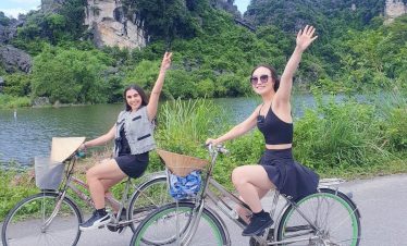 Cycling through lush landscapes in Ninh Binh with friends, enjoying nature and tranquility.