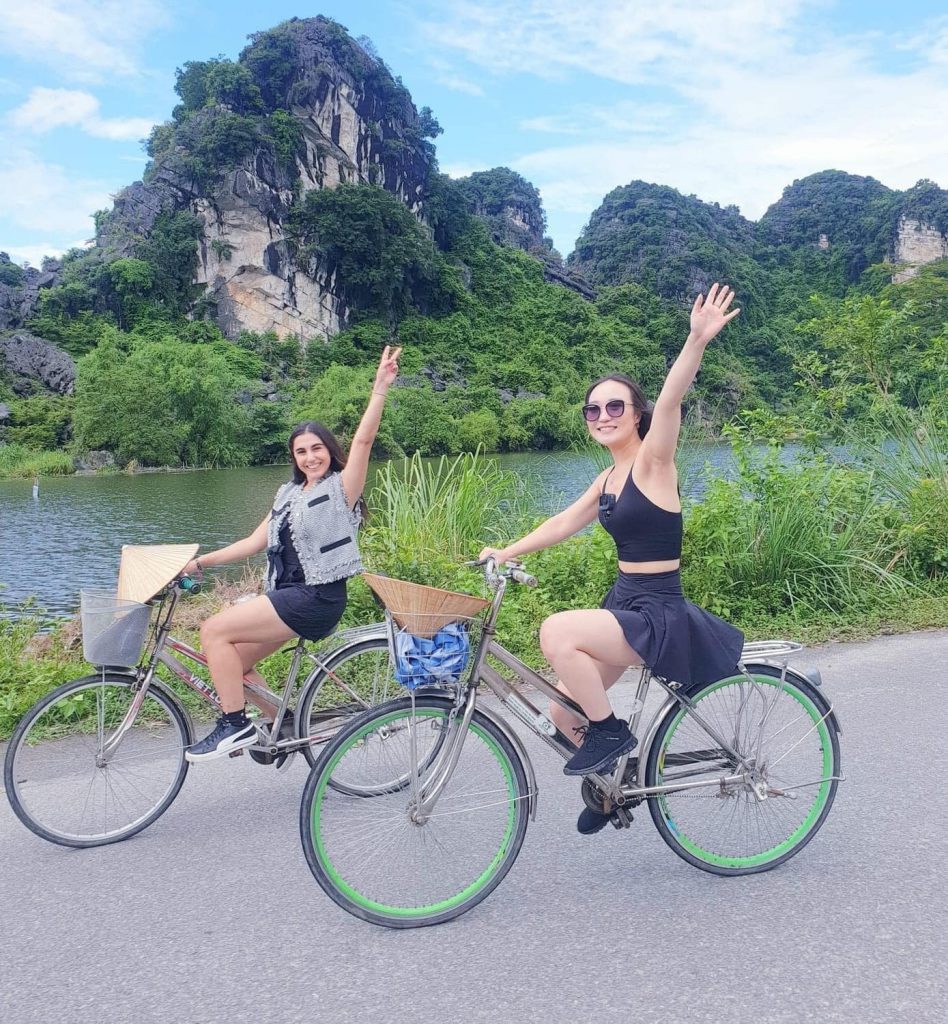 Cycling through lush landscapes in Ninh Binh with friends, enjoying nature and tranquility.