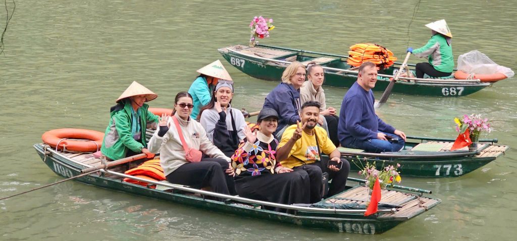 Lan Ha Bay cruise scene with happy travelers enjoying a scenic boat ride in tranquil waters.