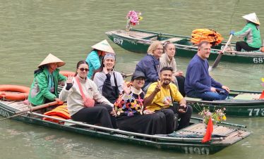 Lan Ha Bay cruise scene with happy travelers enjoying a scenic boat ride in tranquil waters.