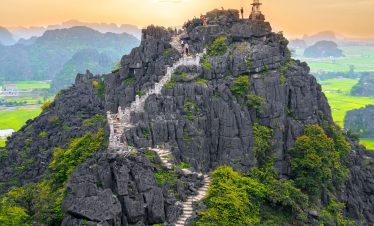Scenic mountain trekking in Vietnam with lush greenery and stunning views, perfect for adventure tra.