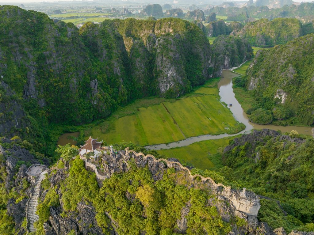 Scenic view of lush green mountains and river in Sapa, Vietnam, perfect for trekking adventures.