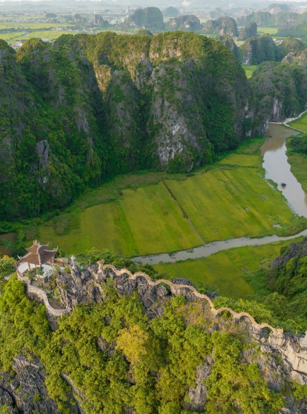 Scenic view of lush green mountains and river in Sapa, Vietnam, perfect for trekking adventures.