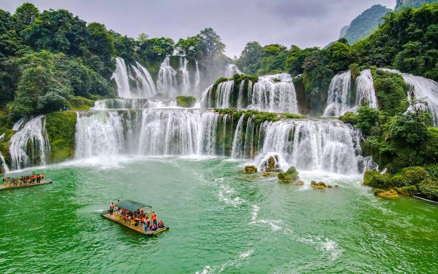 Stunning waterfall scene in Vietnam with lush greenery and cascading waters, perfect for adventure a.
