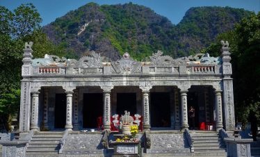 Stunning view of mountain temple in Sapa with lush greenery and traditional architecture.