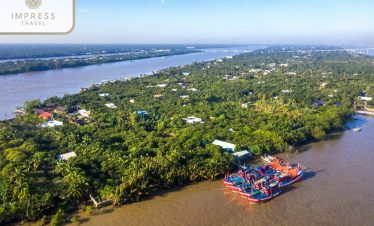 Stunning aerial view of Mekong River with lush greenery and traditional boats, perfect for a luxurio.