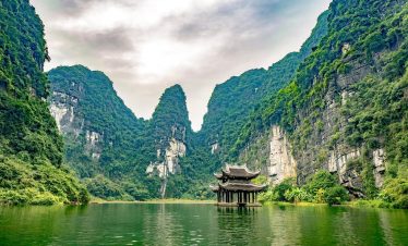 Beautiful Lan Ha Bay landscape with lush green cliffs and tranquil waters, perfect for a relaxing cr.