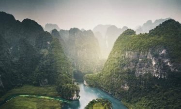 Stunning Lan Ha Bay landscape with lush green islands and calm waters, perfect for a luxurious cruis.
