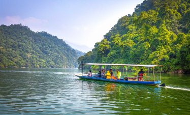 Scenic Halong Bay cruise with lush green islands and tranquil waters, perfect for an unforgettable t.