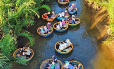 Scenic boat ride through lush green waterways on a traditional Vietnamese bamboo basket boat.