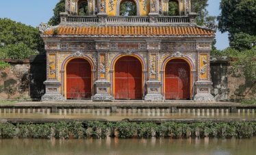 Vivid scene of Hue's ancient gate reflecting on the water, showcasing Vietnam's rich cultural herita.