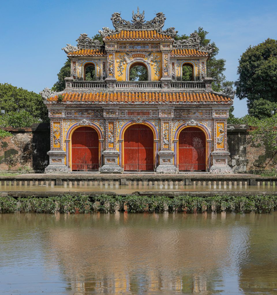 Vivid scene of Hue's ancient gate reflecting on the water, showcasing Vietnam's rich cultural herita.