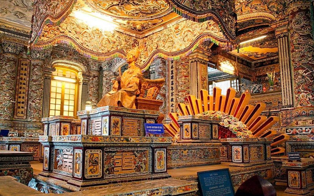 Intricate interior of a historic Vietnamese temple showcasing traditional art and architecture.