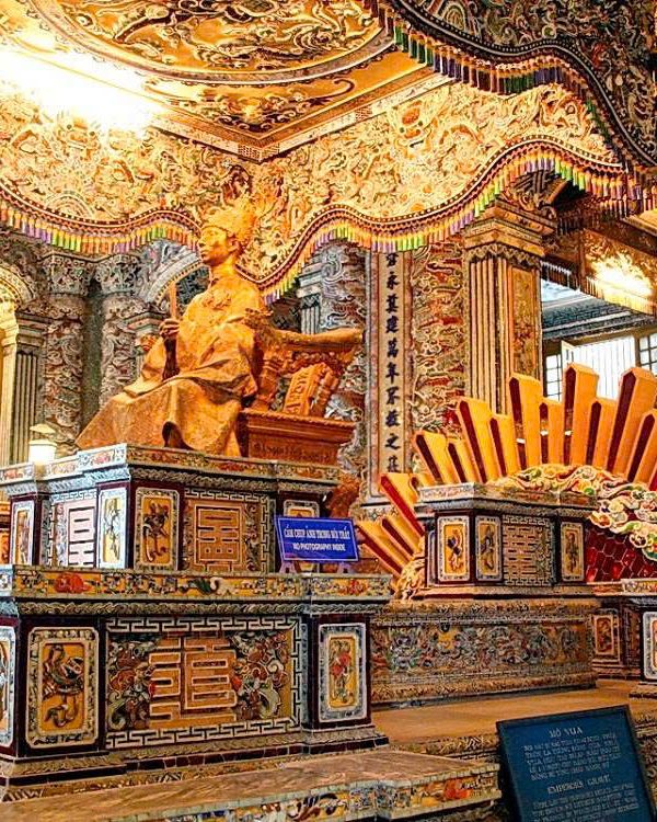 Intricate interior of a historic Vietnamese temple showcasing traditional art and architecture.