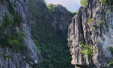 Scenic Lan Ha Bay landscape featuring towering limestone cliffs and tranquil emerald waters, perfect.
