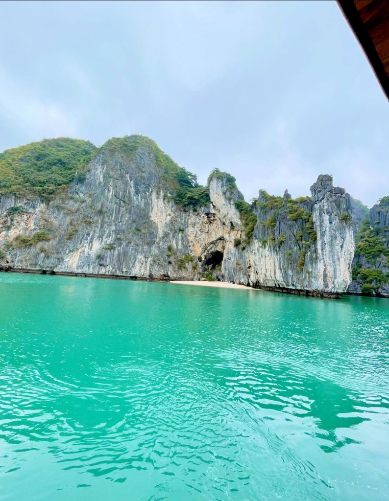 Stunning Lan Ha Bay scenery with turquoise waters and towering limestone cliffs, perfect for a luxur.