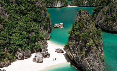 Breathtaking view of Lan Ha Bay's turquoise waters and limestone islands from a luxury cruise balcon.