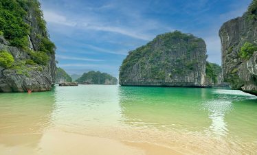 Stunning view of Halong Bay's emerald waters and towering limestone islands, perfect for kayaking an.