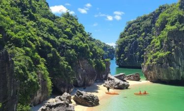 Stunning Halong Bay cruise balcony scene with limestone cliffs and tranquil emerald waters, perfect.