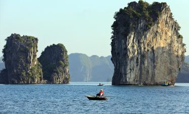 Stunning limestone karsts and tranquil waters in Lan Ha Bay, perfect for a relaxing cruise experienc.