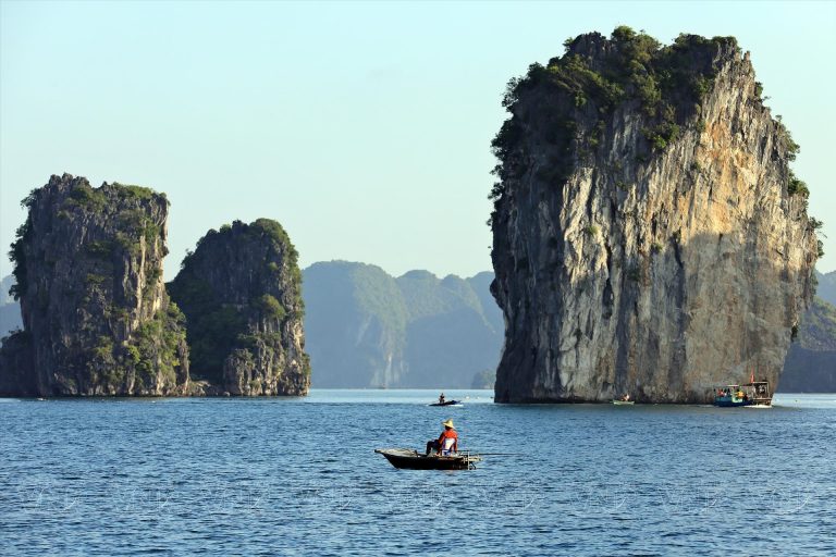 Stunning limestone karsts and tranquil waters in Lan Ha Bay, perfect for a relaxing cruise experienc.