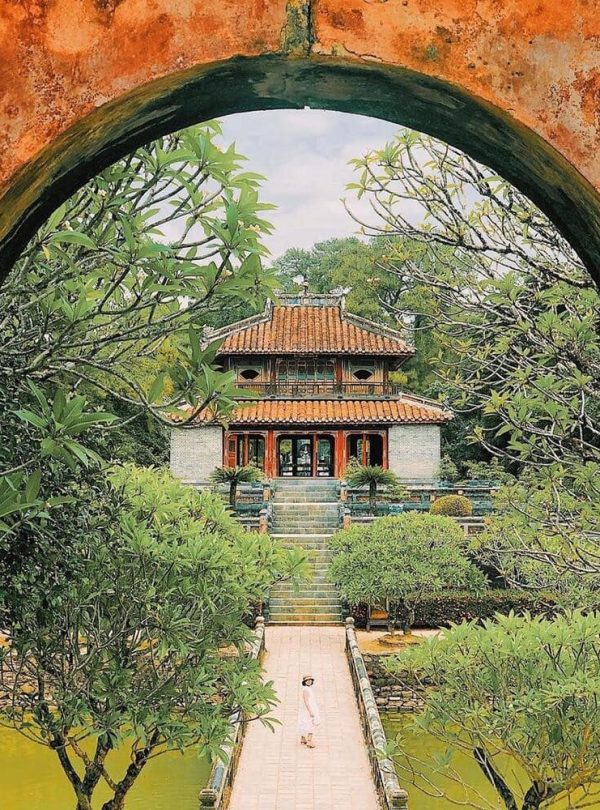 Serene temple scene framed by vibrant greenery, showcasing Vietnam's rich cultural heritage and tran.