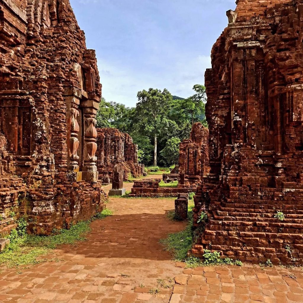 Ancient ruins at My Son Heritage Site in Vietnam, showcasing historic architecture and lush surround.