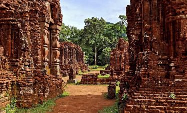 Ancient ruins at My Son Heritage Site in Vietnam, showcasing historic architecture and lush surround.