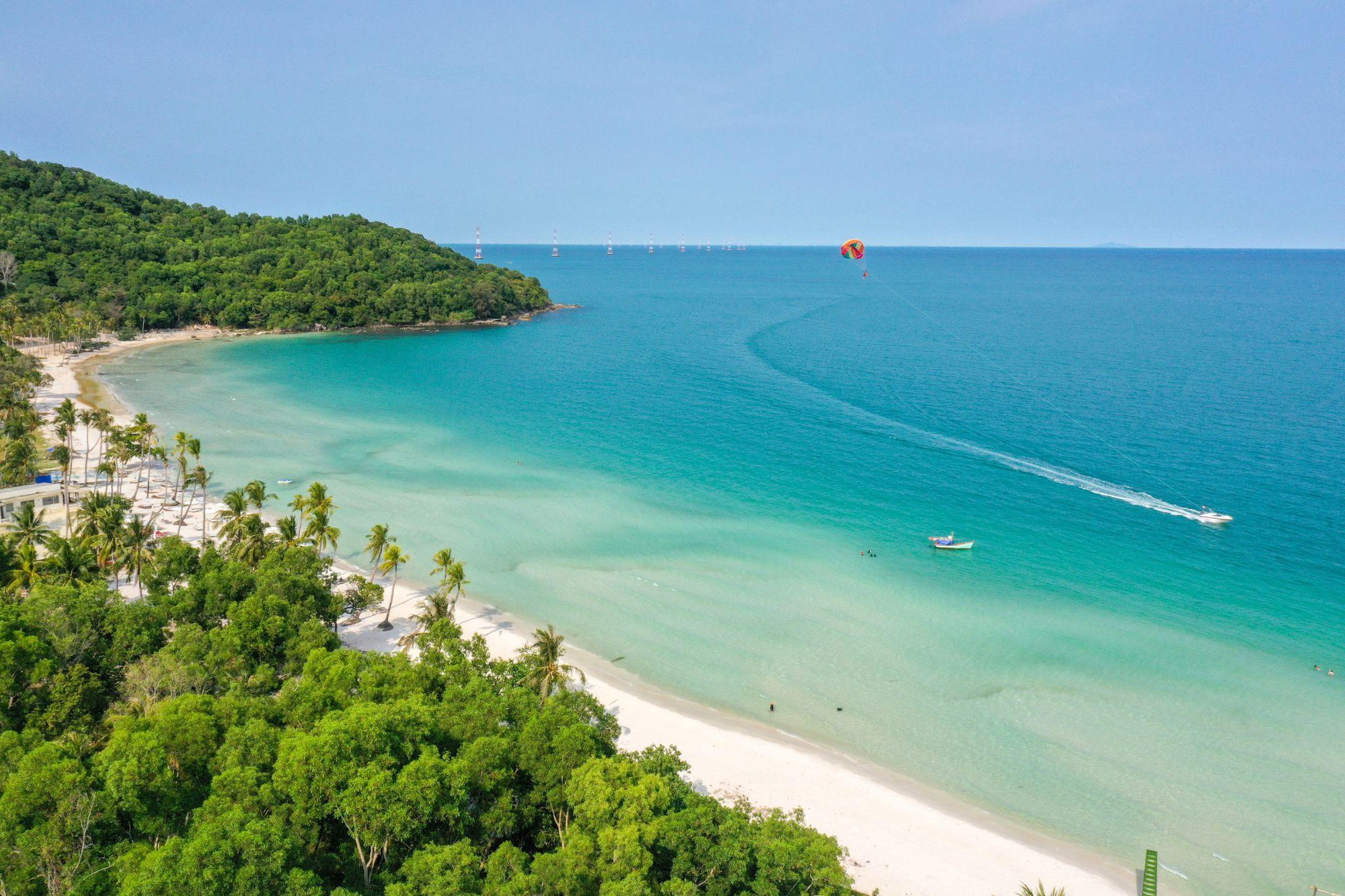 Stunning aerial view of Halong Bay with turquoise waters and lush green islands, perfect for a luxur.