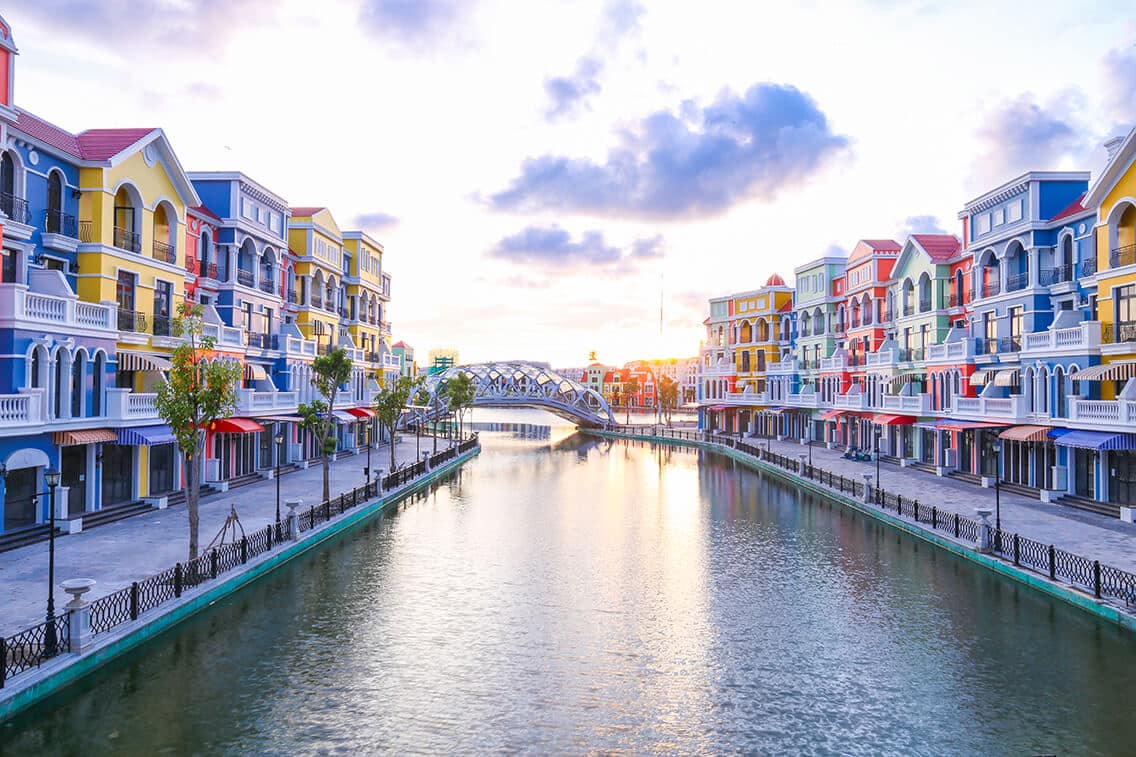 Vibrant colorful buildings along a peaceful canal in Vietnam, perfect for exploring local culture an.