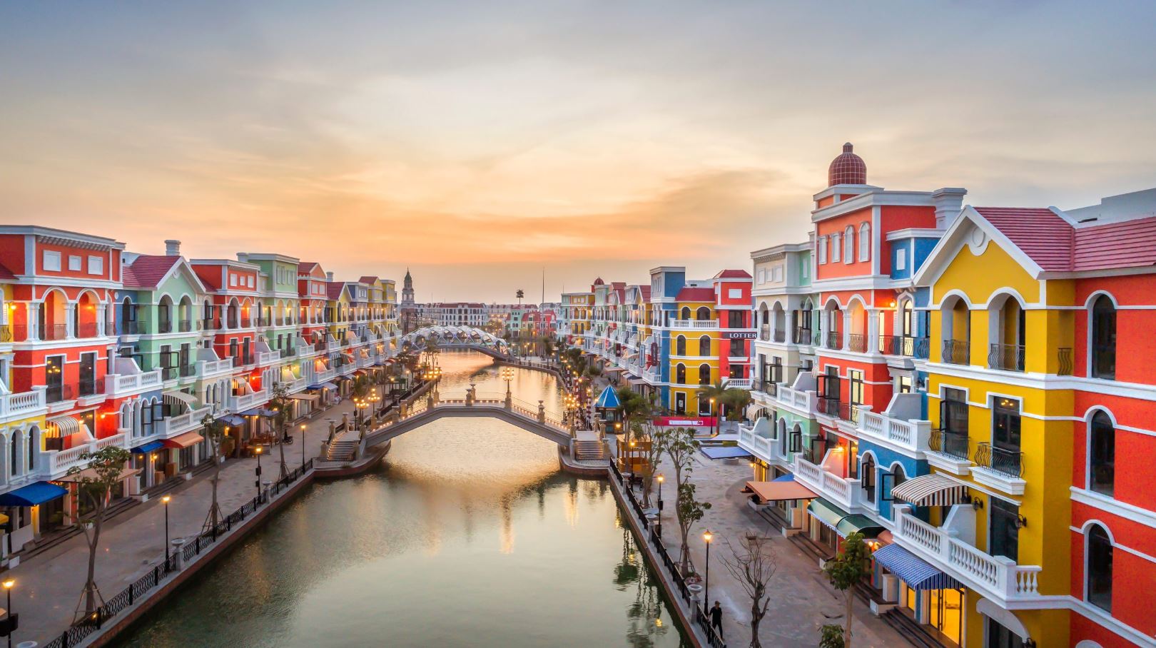 Colorful canal-side town in Vietnam with vibrant buildings and scenic waterway, perfect for exploring local culture and architecture.