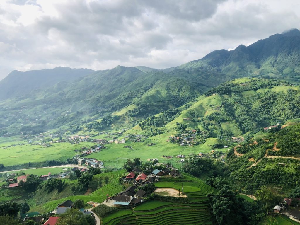 Scenic view of lush green terraced fields and mountain landscape in Sapa, perfect for trekking adven.