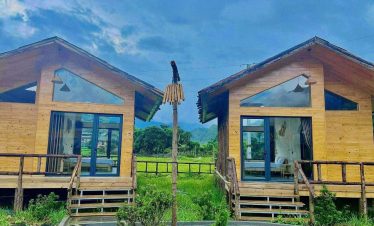 Stunning Ninh Binh hillside view with luxurious villas and lush greenery.
