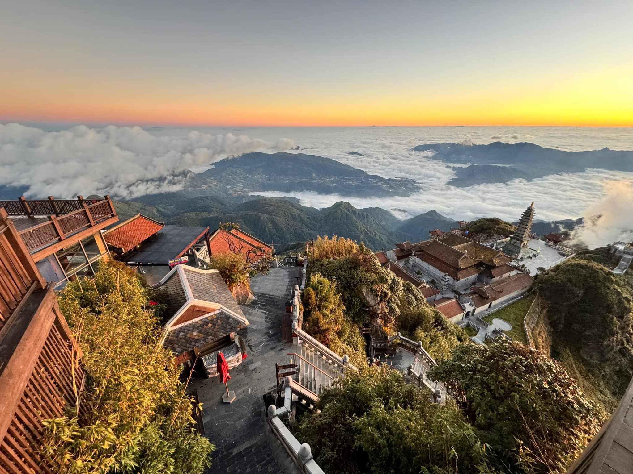 Breathtaking sunset view from the mountain in Vietnam, showcasing lush greenery and traditional arch.