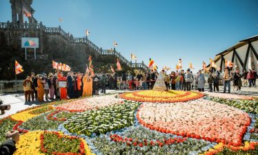 ViettrendTour Vietnam Cultural Festival scene with vibrant flowers and traditional flags, showcasing.
