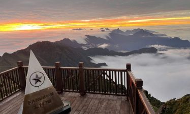 Spectacular sunrise view from Fansipan mountain with clouds and mountain peaks, perfect for adventur.