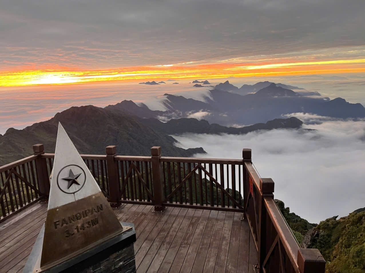 Spectacular sunrise view from Fansipan mountain with clouds and mountain peaks, perfect for adventur.