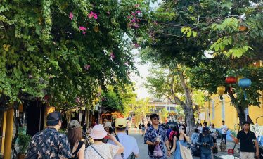 Vibrant street scene in Vietnam with tourists exploring colorful shops and local life, capturing the.
