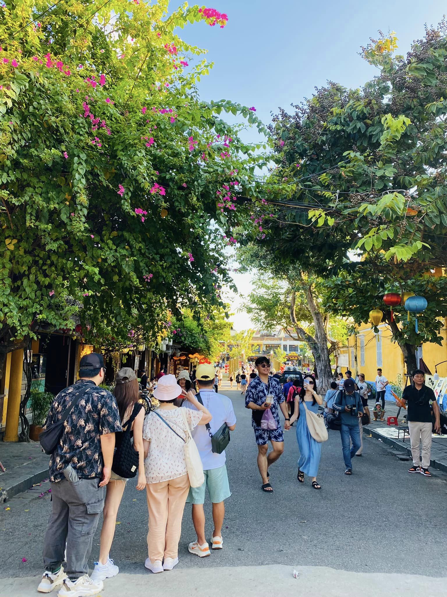 Vibrant street scene in Vietnam with tourists exploring colorful shops and local life, capturing the.