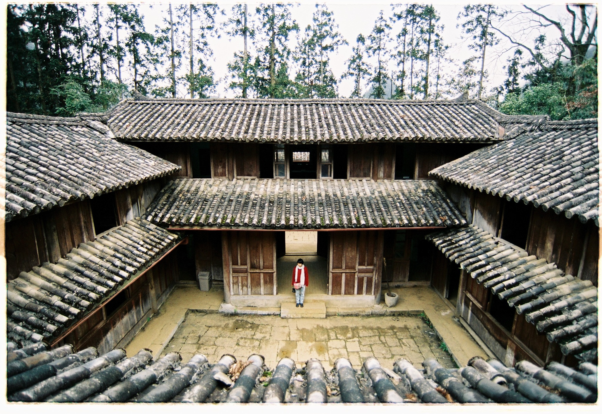 Ancient wooden house in Sapa surrounded by lush forest, showcasing authentic local architecture and.