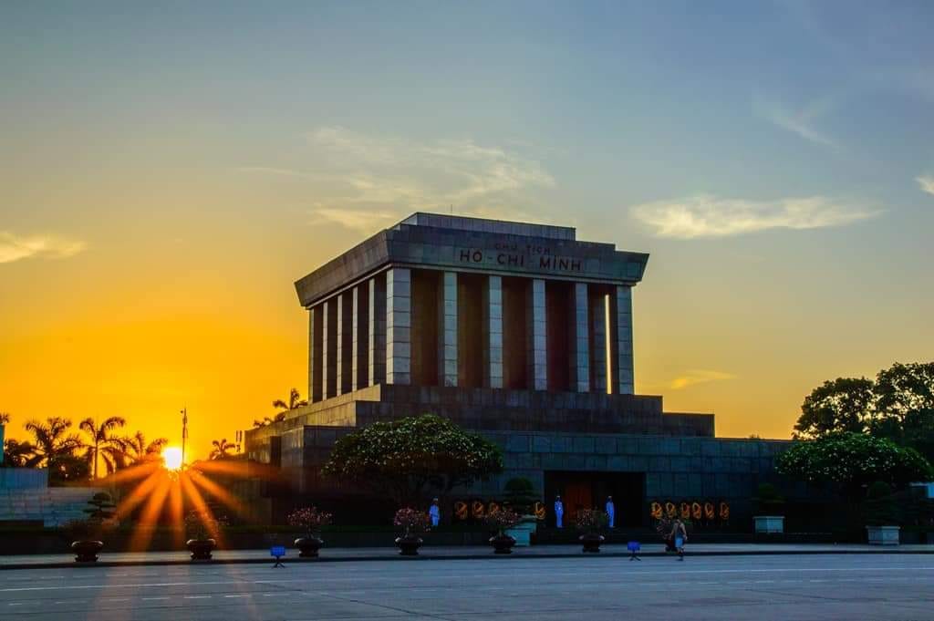 Vietnam War Memorial Hanoi at sunset with vibrant sky and peaceful ambiance.