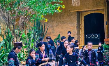 Vibrant scene of local villagers in traditional attire performing cultural dance at a Vietnam ethnic.